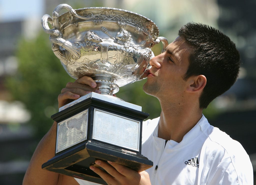 Novak Djokovic of Serbia kisses his trophy following his victory at the Men's Singles at the Australian Open 2008.