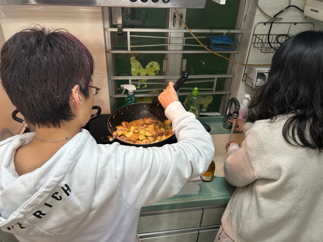 Angel, who took part in ImpactHK's co-living programme, helps prepare a meal. Photo: ImpactHK.