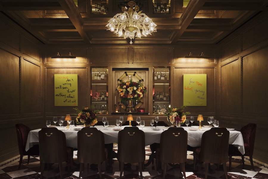carbone london major food group mfg ken fulk private dining room gold trim murano glass chandelier communal table white tablecloth black and white checkerboard floor