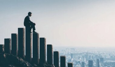 Businessman in a suit sitting on tall bar-chart pillars overlooking a city, symbolizing economic and hiring trends