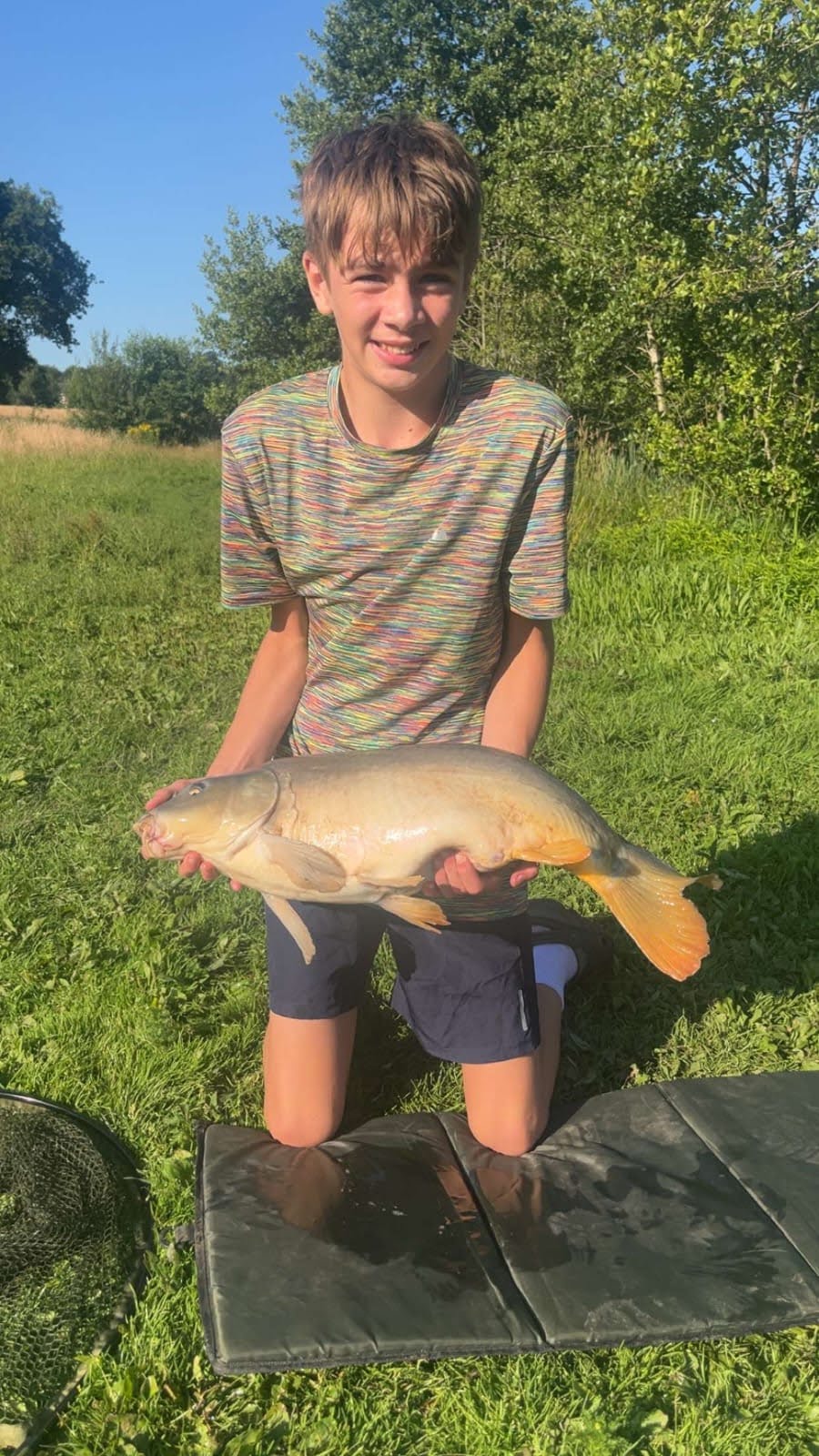 His family shared a picture of their son holding a large fish after a fishing trip