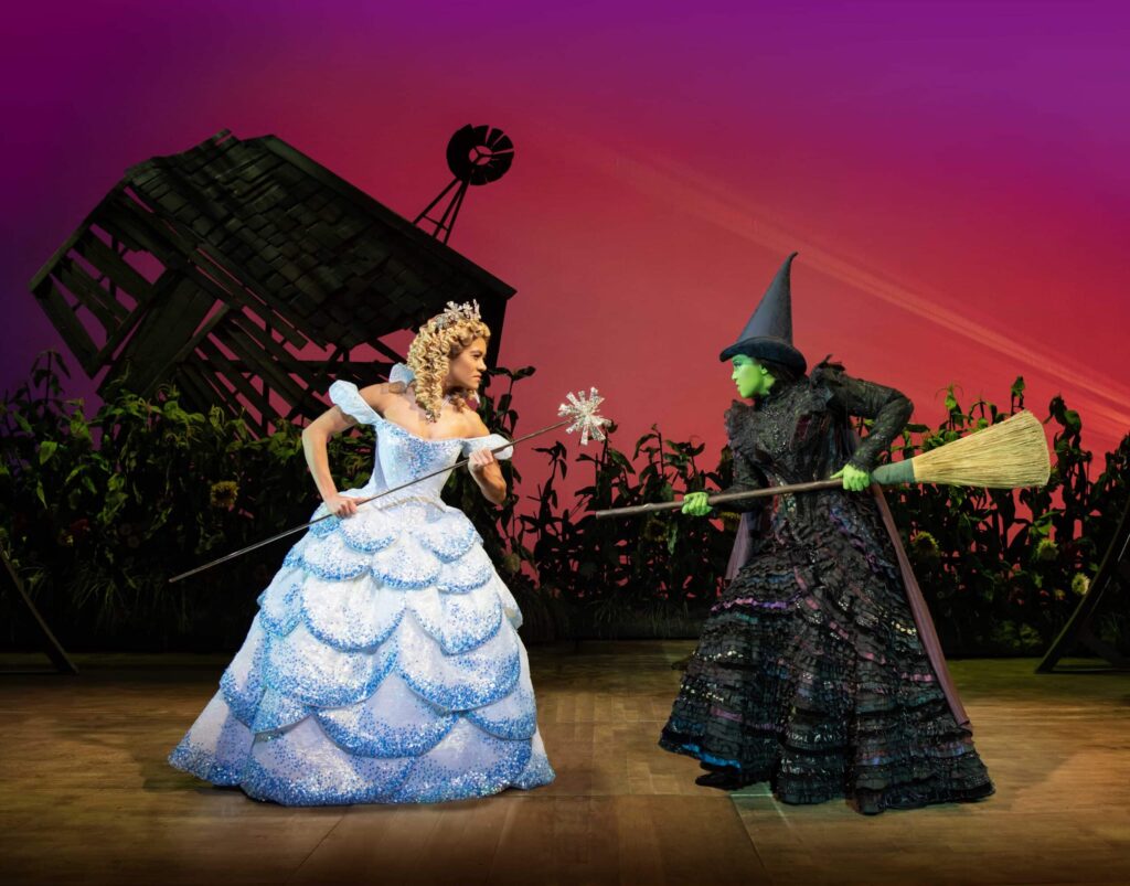 The actresses portraying Glinda and Elphaba on stage for a performance of Wicked on the West End