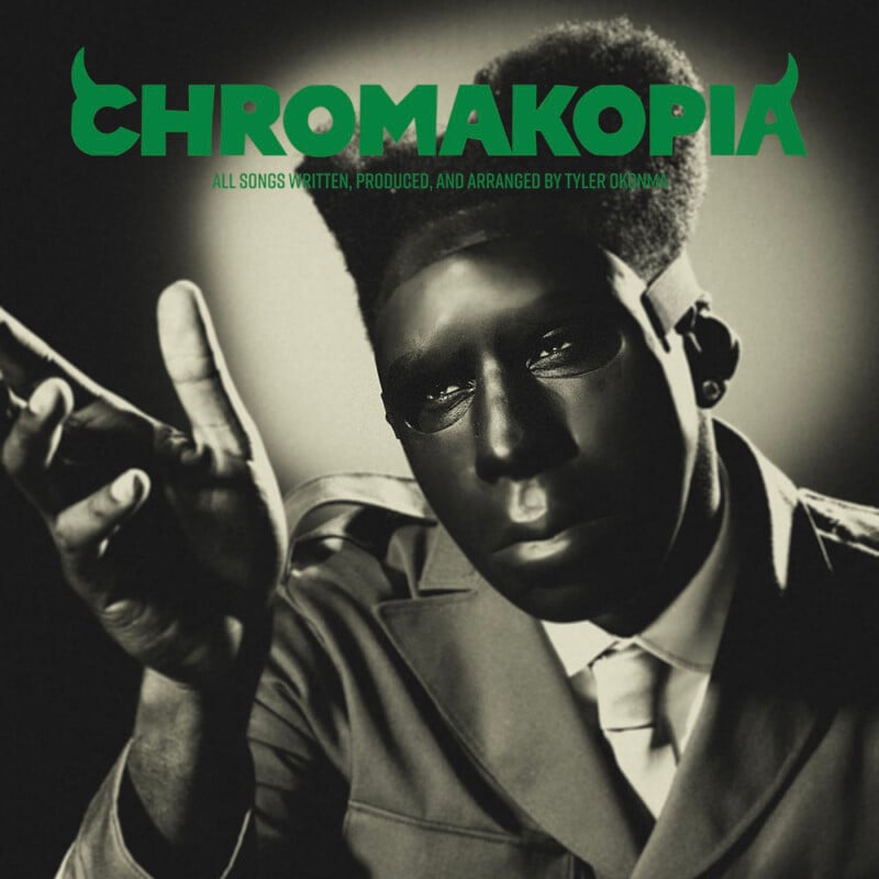 A person in a suit with a high flat-top hairstyle wears a shiny black mask. The word "CHROMAKOPIA" appears in bold green letters at the top, with smaller text below. The image has a vintage, high-contrast style.