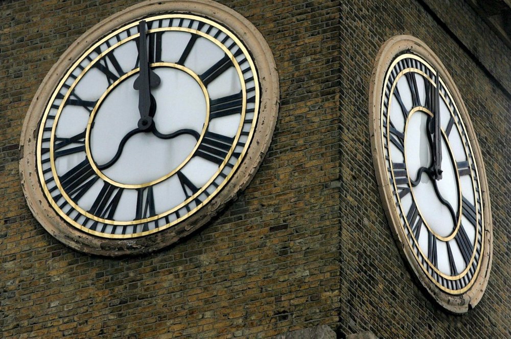 Man climbs King's Cross clock tower in London with dog to protest Iran