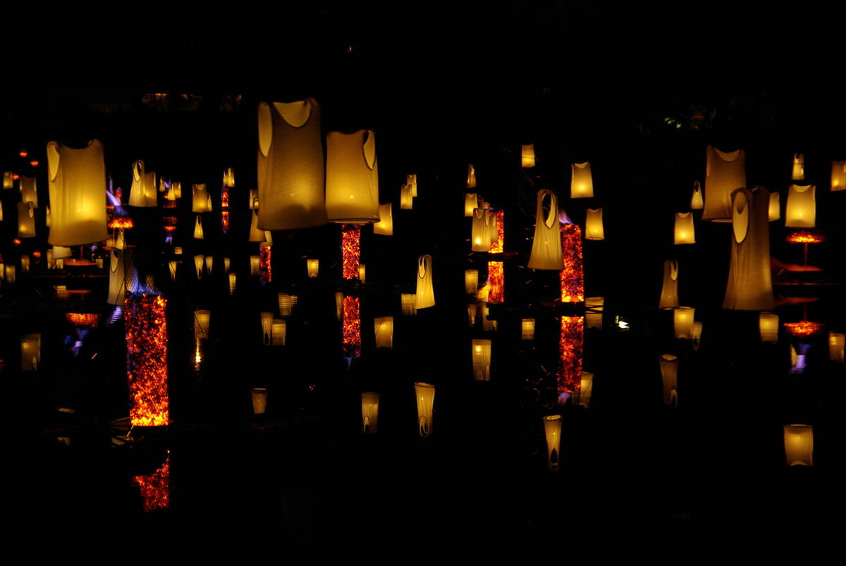 lanterns lit up by fire floating in the air