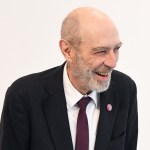 A smiling man in a suit.