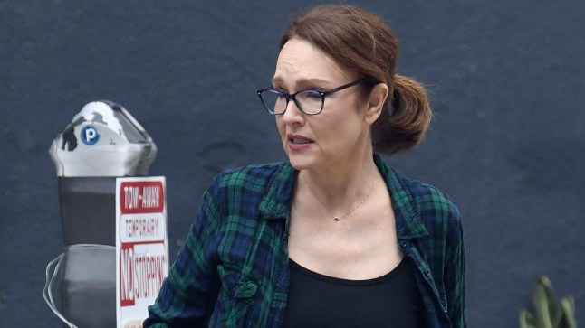 Amy Yasbeck pictured out in LA by a parking meter in cargo trousers, a black vest and check shirt over the top on September 12, 2025, looking ageless
