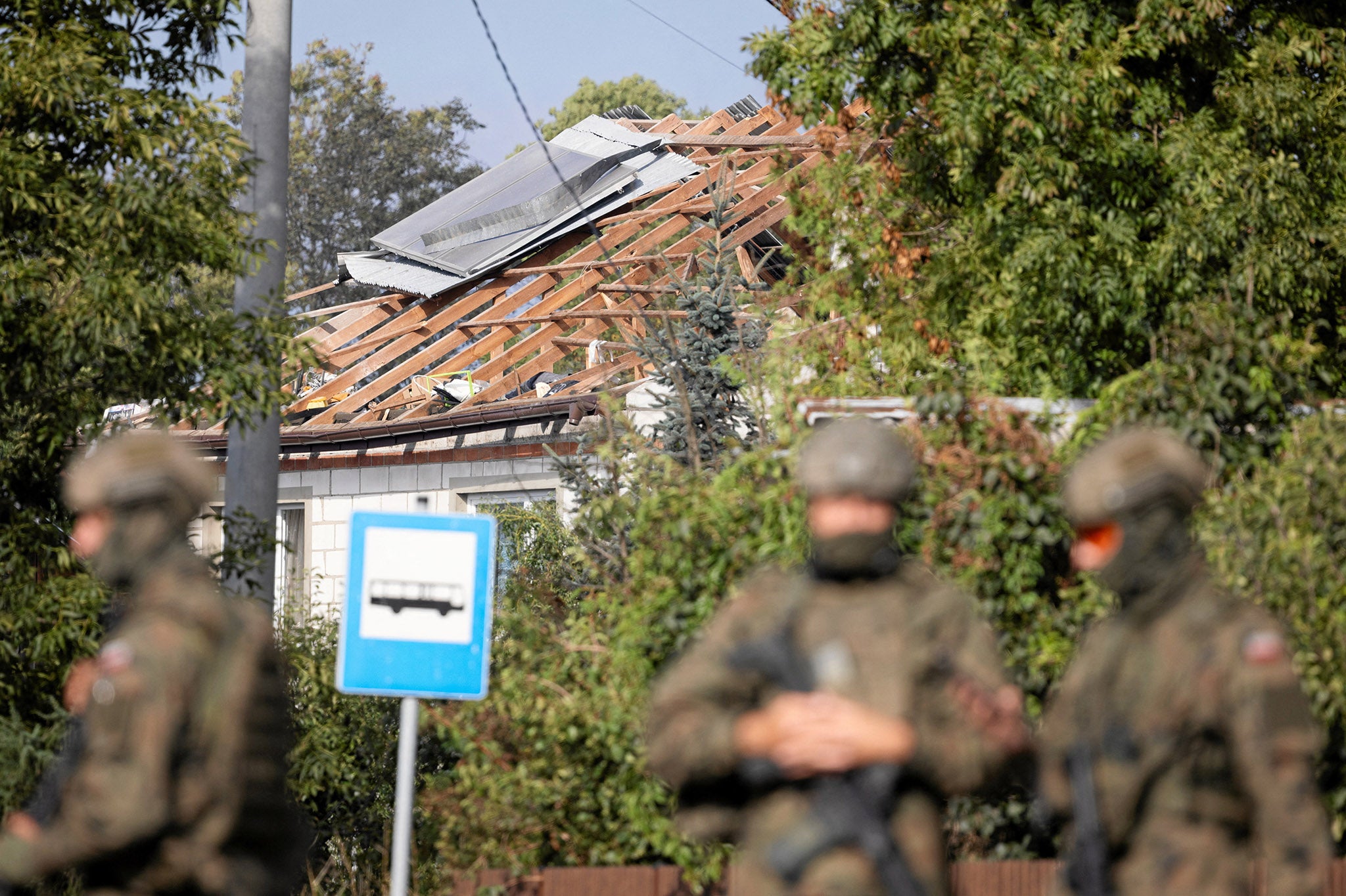 Soldiers patrol the street in Wyryki after a house was struck by a drone launched by Russia over Polish airspace