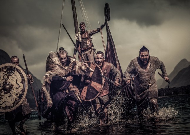 Mad vikings warriors in the attack, running along the shore with Drakkar on the background.; Shutterstock ID 503301562; purchase_order: -; job: -; client: -; other: -
