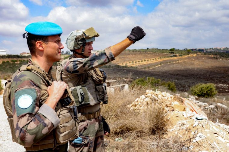 Colonel Arnaud de Coincy (L), commander of the Force Mobile Reserve of the United Nations Interim Force in Lebanon (UNIFIL), stands next to a peacekeeper during a tour in the village of Kfar Kila in southern Lebanon near the border with northern Israel on August 27, 2025. (Photo by ANWAR AMRO / AFP) (Photo by ANWAR AMRO/AFP via Getty Images)