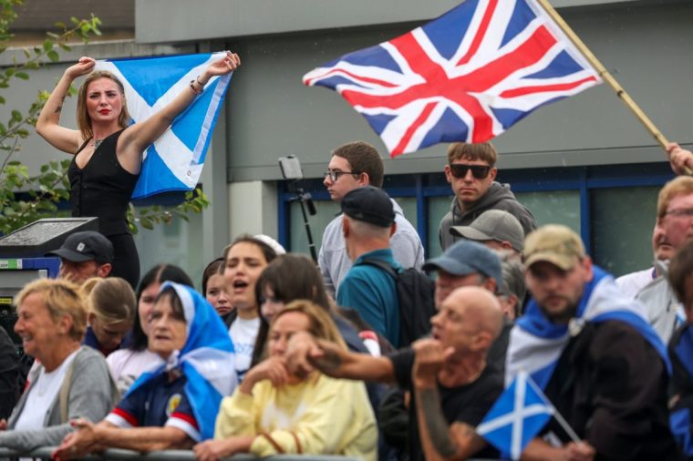 FALKIRK, SCOTLAND - AUGUST 30: Anti-migrant protesters demonstrate outside the Cladhan Hotel on August 30, 2025 in Falkirk, Scotland. Hotels housing migrants in Scotland have become a target for anti-migrant protests organised by far-right groups and attended but local residents. Stand up to Racism and other anti-racist groups have mounted counter-protests saying all people should be welcome. (Photo by Jeff J Mitchell/Getty Images)
