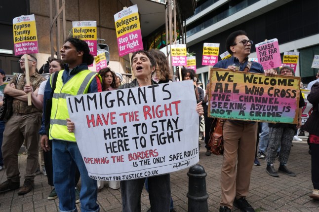 People take part in a Stand Up To Racism counter protest outside the Britianna Hotel in Canary Wharf, east London. Picture date: Sunday August 31, 2025.