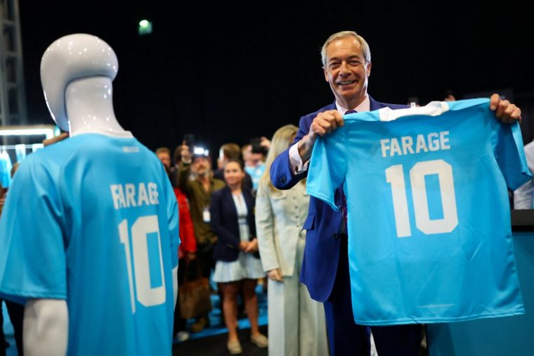 Britain's Reform UK party leader Nigel Farage holds a football shirt with his surname during the Reform UK party conference, in Birmingham, Britain, September 6, 2025. REUTERS/Isabel Infantes
