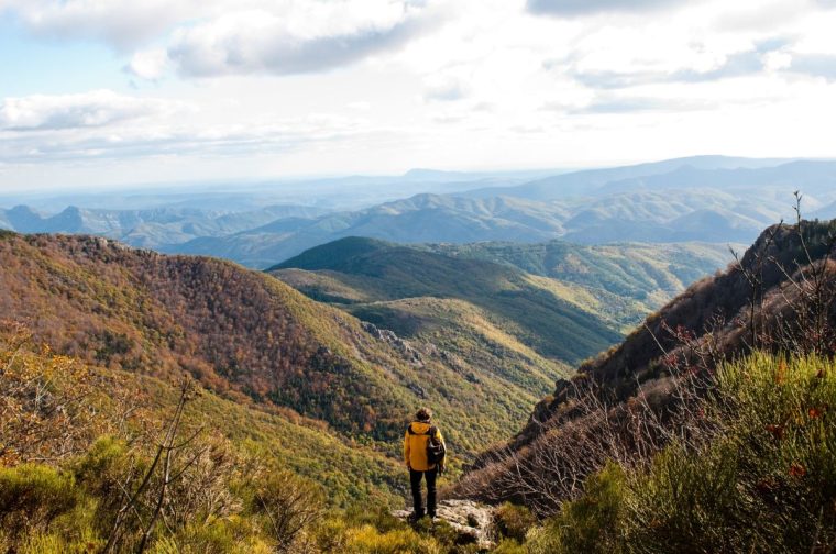 Man looking over the Cevennes mountains in the Cevennes National Park. This range of mountains is located in south-central France, covering parts of the departments of Ardeche, Gard, Herault and Lozere, France