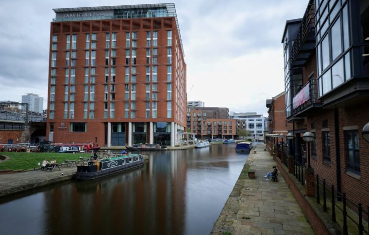 Leeds, UK 04 11 2024 Hilton Double Tree hotel beside the Leeds Liverpool Canal in the centre of the city. A long exposure during the day to smooth the canal water.