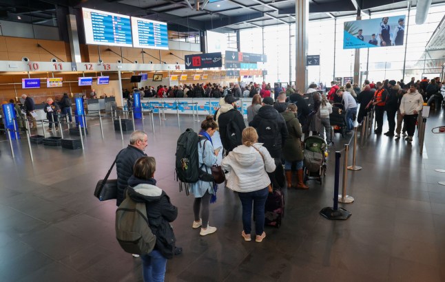 Illustration picture shows passengers queue caused by police actions at Brussels South Charleroi Airport (BSCA), in Gosselies, Thursday 09 March 2023. This action, toegether with the symbolic police stations both from the federal and the local polices, is to ask to keep their rights to early retirement, before the age of 67, and salaries to be increased and the recurrent problem of lack of personnel to be solved. BELGA PHOTO VIRGINIE LEFOUR (Photo by VIRGINIE LEFOUR / BELGA MAG / Belga via AFP) (Photo by VIRGINIE LEFOUR/BELGA MAG/AFP via Getty Images)