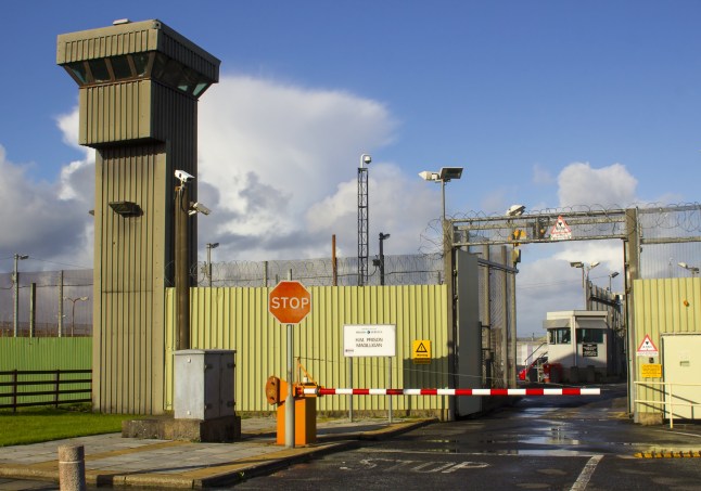 The entrance gate and high observation towers and security fencing at Magilligan Prison in County Londonderry on the North Coast of Ireland