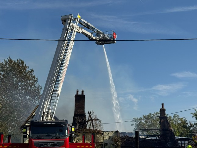 Bedfordshire Fire & Rescue with one of their trucks pouring water on the blaze