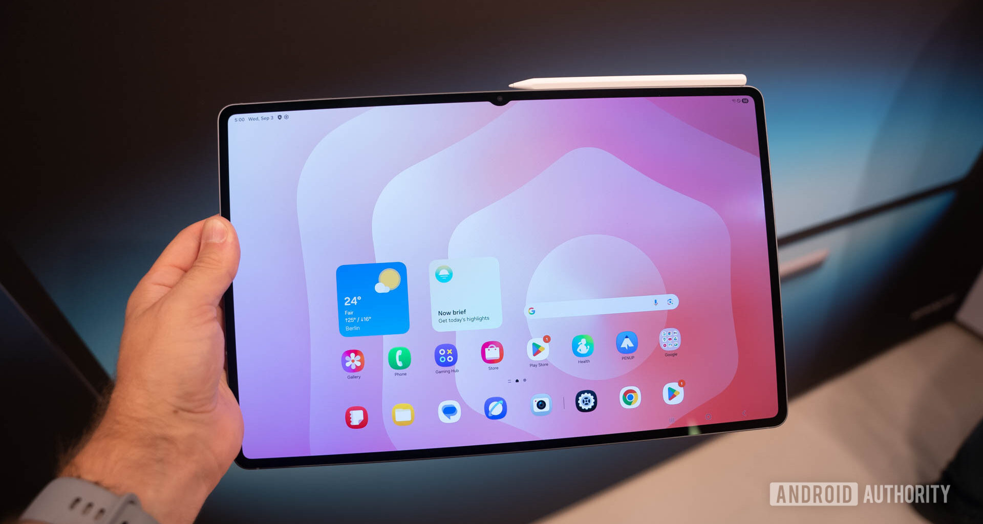 Samsung Galaxy Tab S11 Ultra in man's hand showing home screen