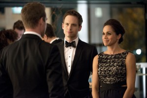 SUITS, (from left): Gabriel Macht (back to camera), Patrick J. Adams, Meghan Markle, 'War', (Season 2, ep. 216, aired Feb. 21, 2013). photo: Christos Kalohoridis / ©USA Network / Courtesy: Everett Collection