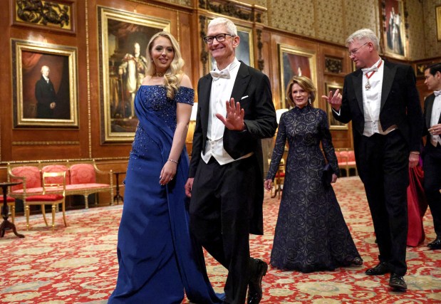 WINDSOR, ENGLAND - SEPTEMBER 17: Apple CEO Tim Cook and Tiffany Trump walk to attend the State visit by the President of the United States of America at Windsor Castle on September 17, 2025 in Windsor, England. President Trump is in England from Sept. 16-18 on his second UK state visit, with the previous one taking place in 2019 during his first presidential term. (Photo by Kevin Lamarque - WPA Pool/Getty Images)