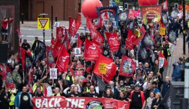 March with lots of red flags, balloons and banners
