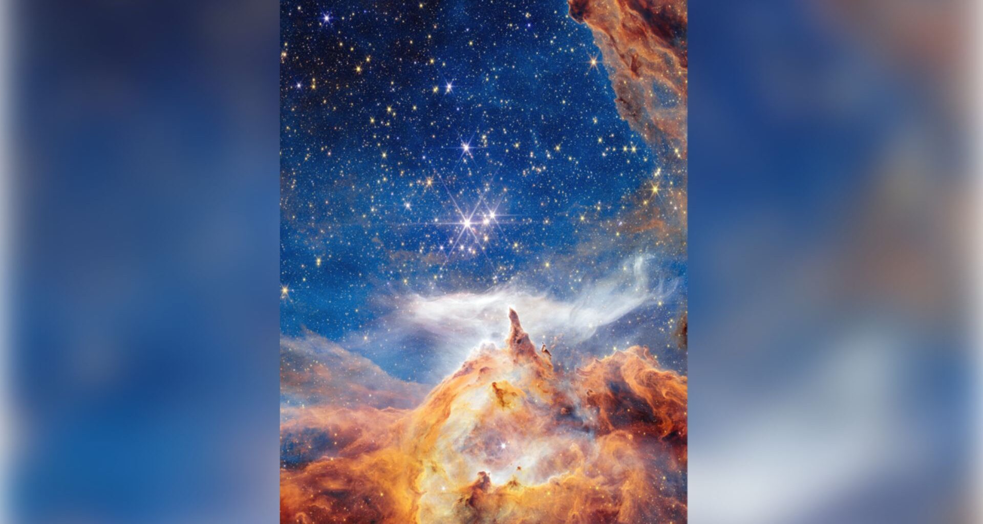 Glowing clouds of orange and blue dust swirl around three bright stars