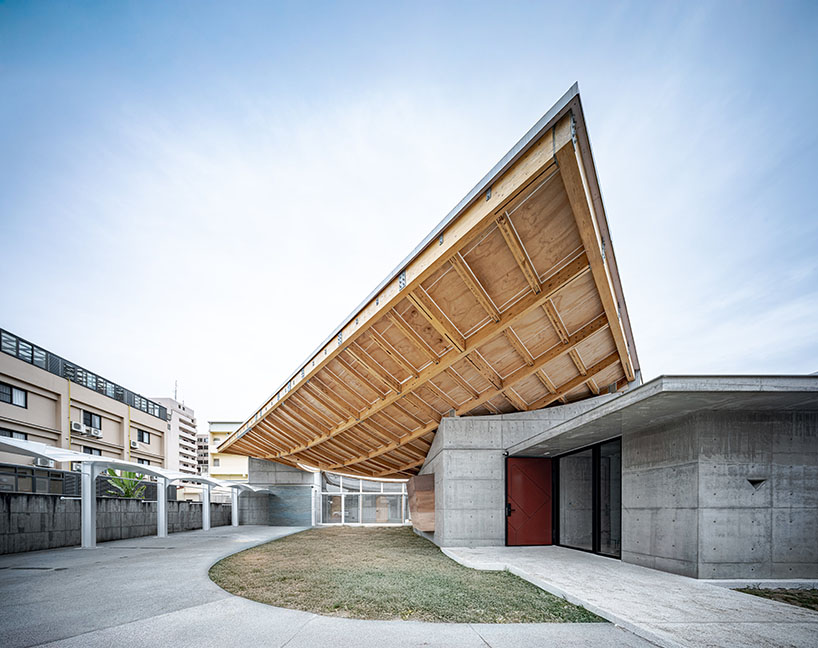 hyperbolic roof composed of curved timber slats tops concrete residence in taiwan