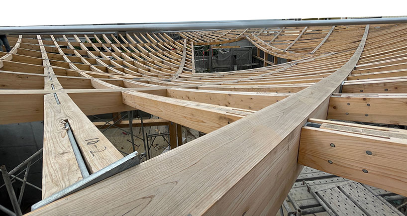 hyperbolic roof composed of curved timber slats tops concrete residence in taiwan