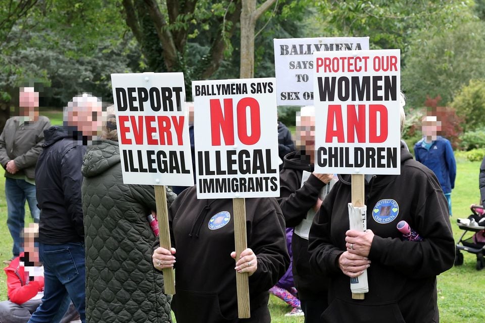 Signs being held at a previous anti-Immigration protest in Stormont Estate