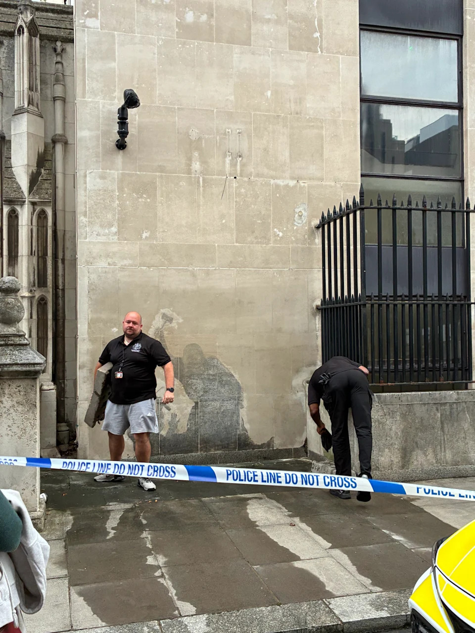 Workers were seeing washing the mural away after it appeared on the wall on Monday. (SWNS)