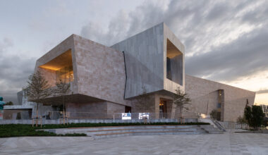 kazakhstan's almaty museum of arts completes as pair of stone and aluminum volumes