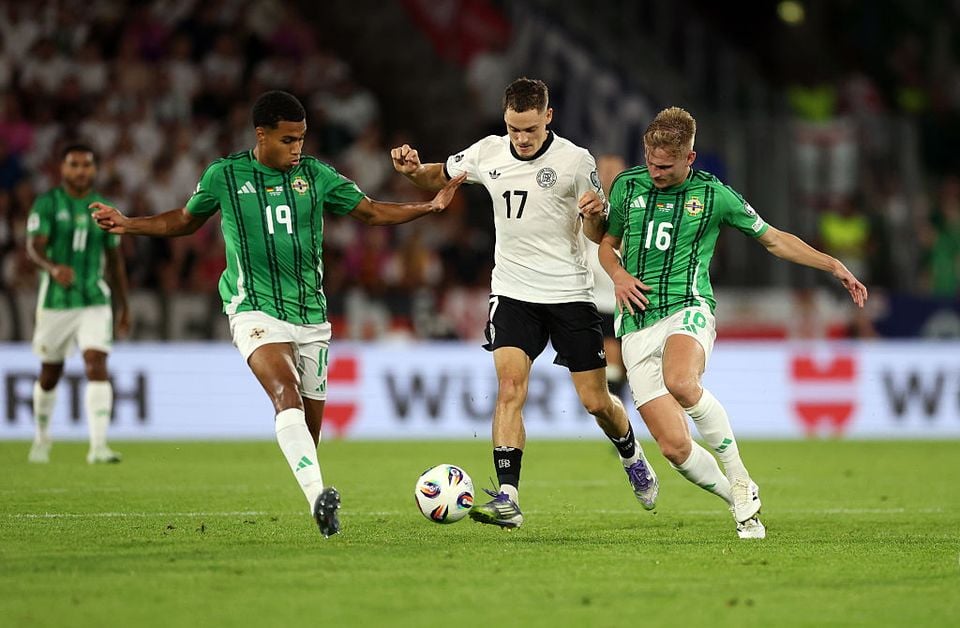 Northern Ireland pair Shea Charles (left) and Ali McCann put pressure on Germany's Florian Wirtz (Getty Images)