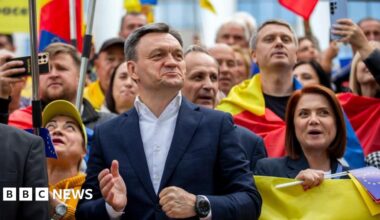 Prime Minister of Moldova Dorin Recean (C) attend a march to support the voting process at parliamentary elections in front of Parliament of Moldova in Chisinau