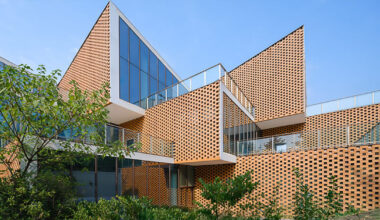 permeable terracotta brick screens wrap kindergarten's stacked volumes by NAN architects