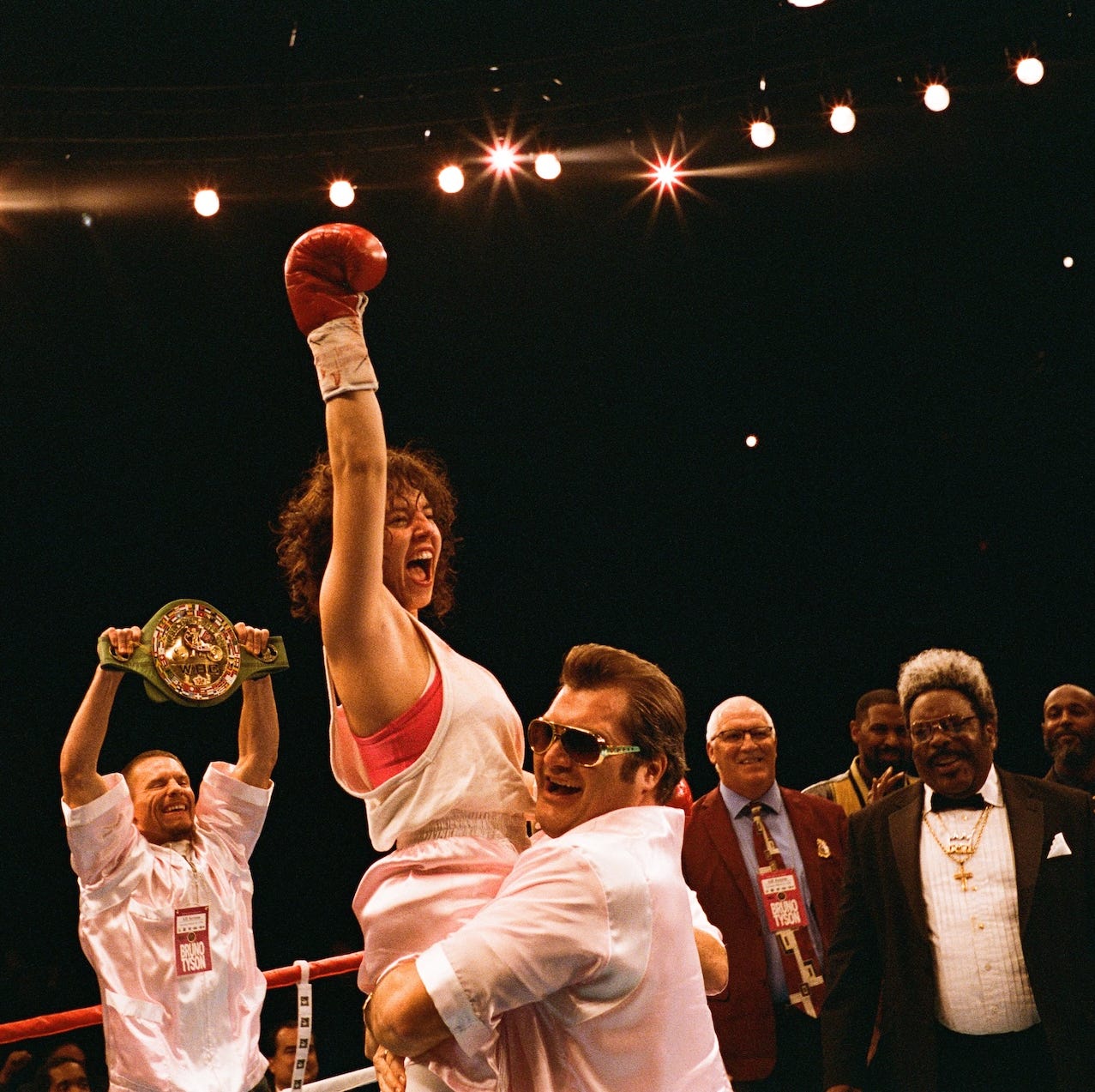 victorious boxer celebrating with a championship belt