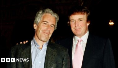 Jeffrey Epstein and Donald Trump pose for a photo together in 1997 with Trump putting his right hand on Epstein's left shoulder.