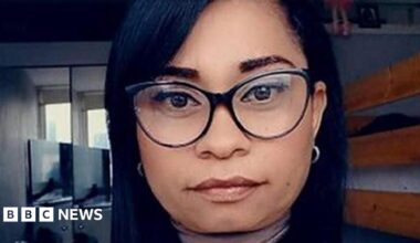 Selfie of a woman who has thick-rimmed glasses and long straight black hair