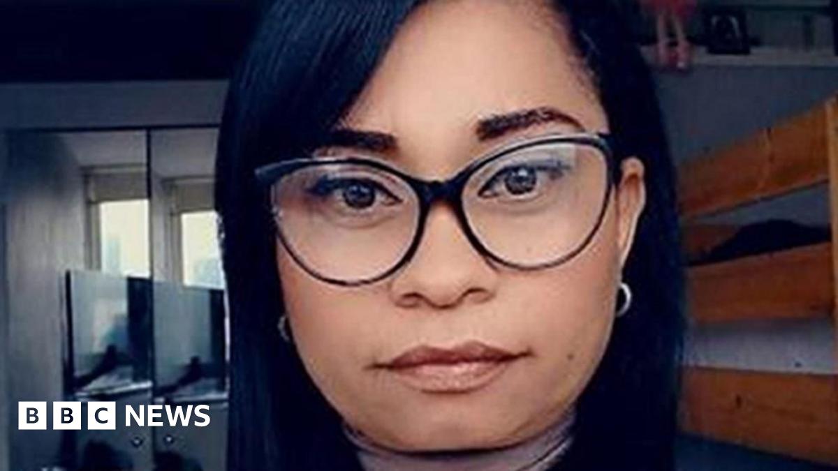 Selfie of a woman who has thick-rimmed glasses and long straight black hair