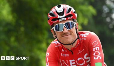 Geraint Thomas wearing sunglasses smiles while riding