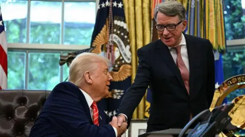 Getty Images Donald Trump turns round to shake hands with a grinning Peter Mandelson in the Oval Office