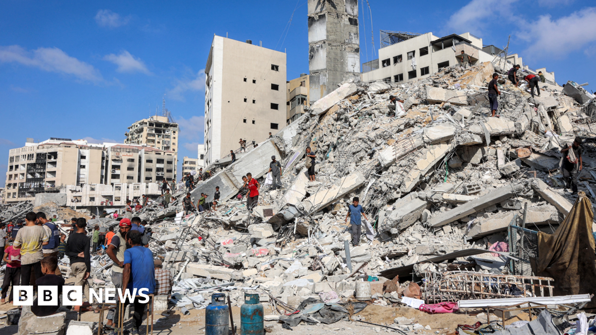 People search for salvage at the mound of rubble at the site of the collapsed Sussi Tower, which was destroyed earlier by Israeli bombardment, in Gaza City on 6 September 2025.