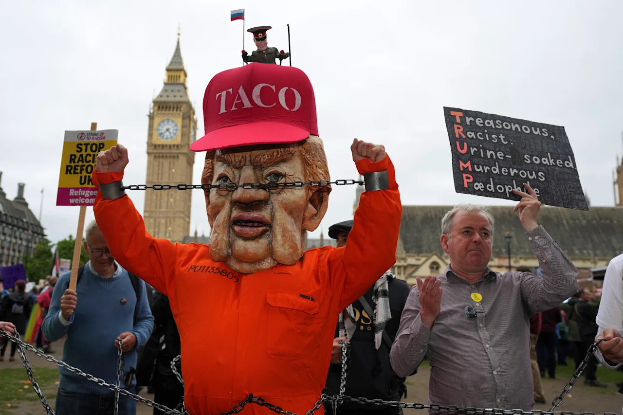 A protester wearing a Trump mask and a costume depicting an inmate jumpsuit at a rally in London 