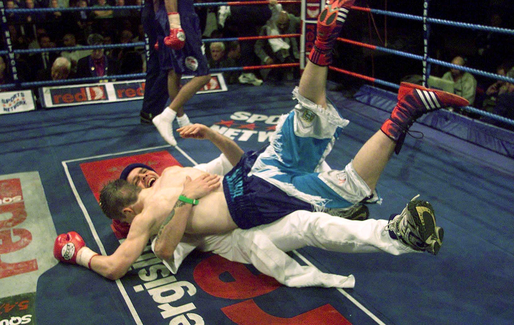 Hatton celebrates with trainer Bill Graham after winning the vacant WBU light-welterweight against Canada’s Tony Pep