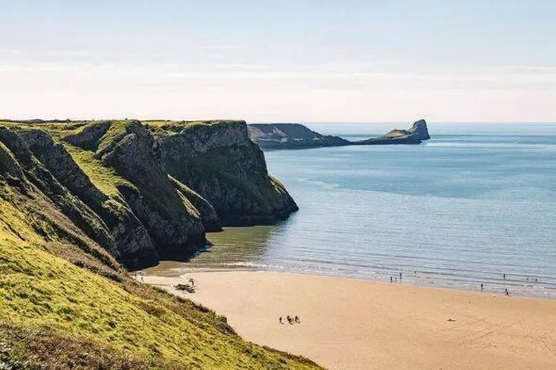 View over the beach in Rhossili Bay to Worm's HEad in the distance