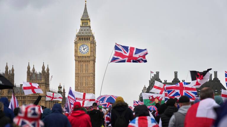 Demonstrators take part in the Tommy Robinson-led Unite the Kingdom march and rally near Westminster
