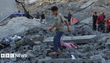 Palestinian man Mohammed Hajjaj stands amid the ruins of a building sheltering displaced families near Firas market in Gaza City, which was destroyed in an Israeli air strike (24 September 2025)
