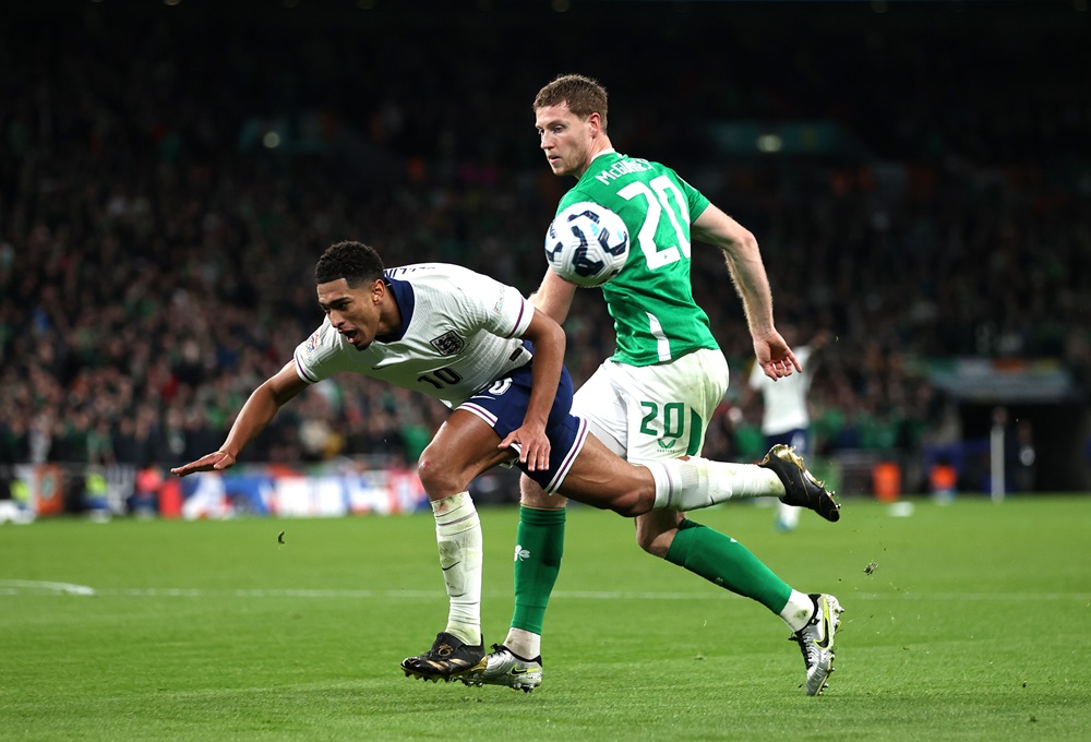 LONDON, ENGLAND: Jude Bellingham of England is tackled by Mark McGuinness of Ireland during the UEFA Nations League 2024/25 League B Group B2 match...
