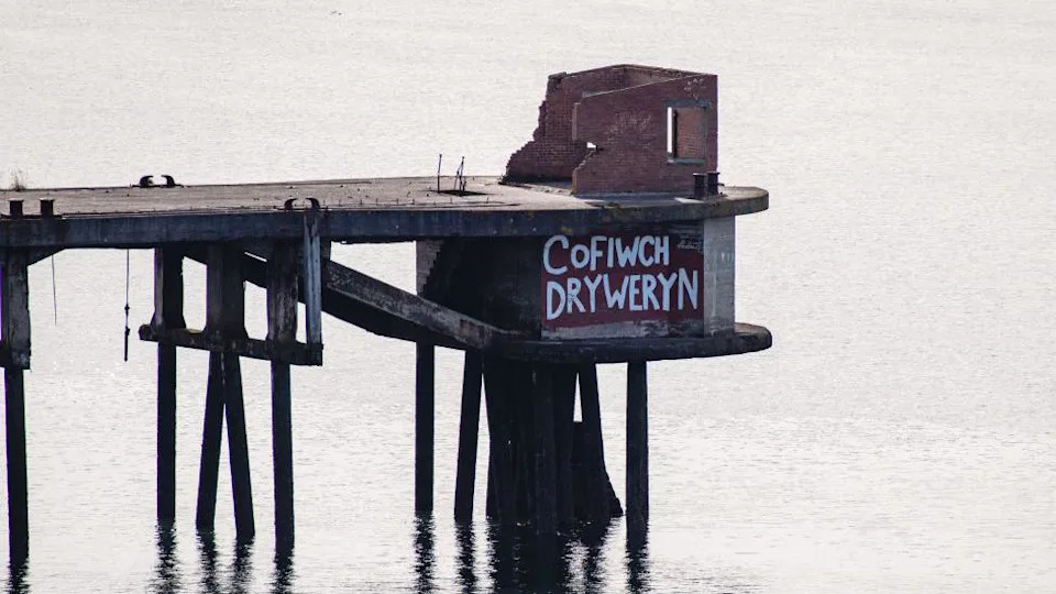 A sign reading "Cofiwch Dryweryn" (meaning "Remember Tryweryn") at the end of a jetty on September 21, 2021 in Milford Haven, Wales. The phrase has become associated with Welsh nationalism and independence political movements.
