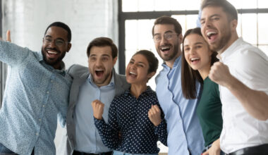 A group of people celebrating in an office.